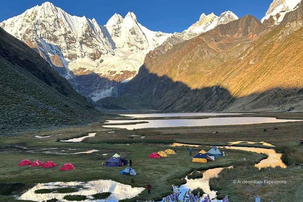 Tents at Jahuacocha lake camp beneath Yerupaja and Rondoy on the Huayhuash trek