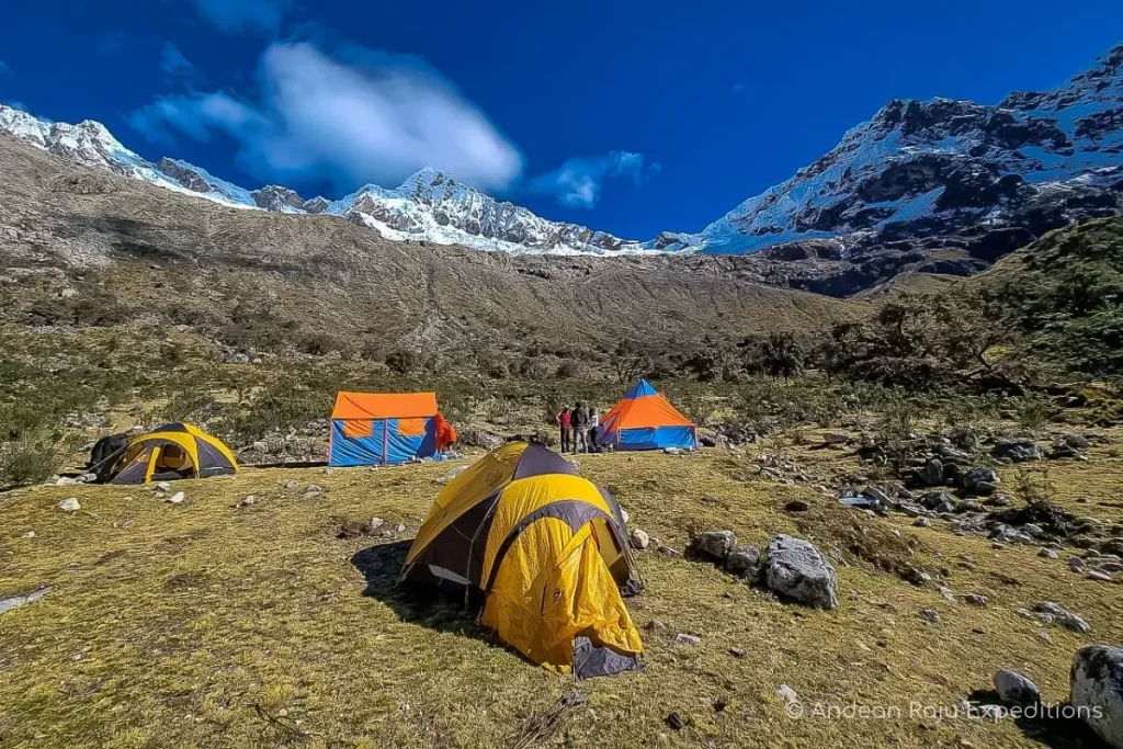 Alpamayo base camp tents with the southwest face in the background