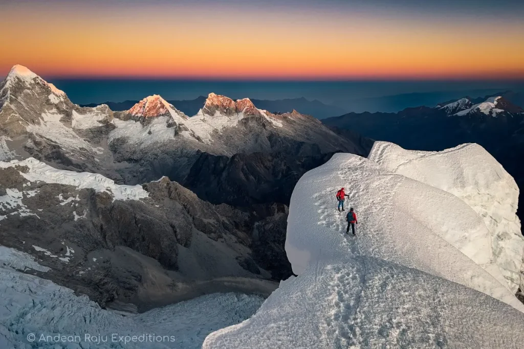 Climbers celebrating on the summit of Alpamayo with Andean Raju Expeditions